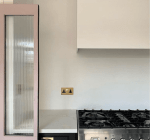 TheHouseThatBlackBuilt_glam_kitchen_in_black_blush_brass_and_reeded_glass_doors