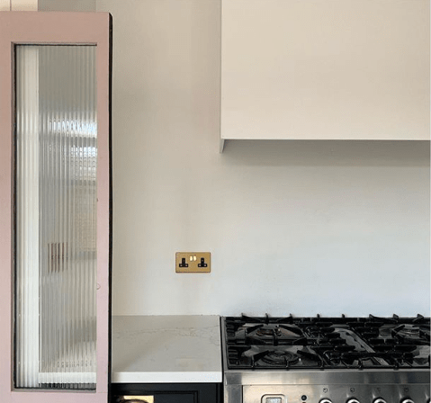 TheHouseThatBlackBuilt_glam_kitchen_in_black_blush_brass_and_reeded_glass_doors